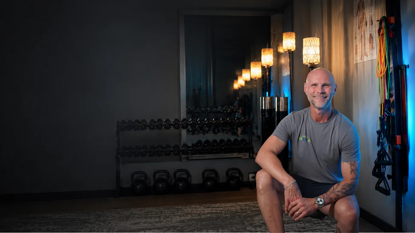 Dr. Kenneth Sullivan-Bol seated in a private training studio